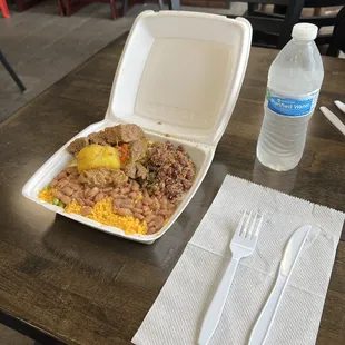 a takeout box of food and a bottle of water