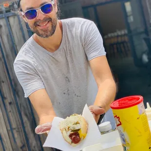 a man holding a hot dog