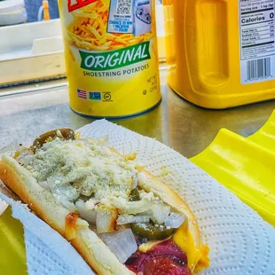 a hot dog with cheese and pickles