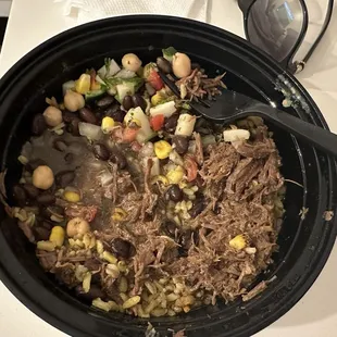 Slow-cooked beef bowl with turmeric rice and salad with chimichurri dressing.