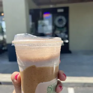 a hand holding a cup of coffee