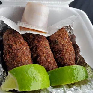 a person holding a container of food