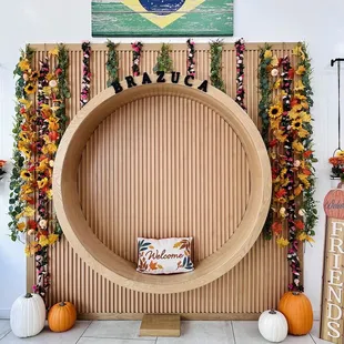 a table with a sign and pumpkins