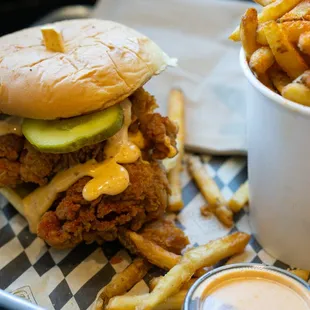a chicken sandwich and fries on a tray