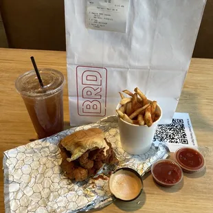 a sandwich, fries and a drink on a table