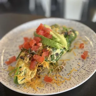an omelet with tomatoes and avocado