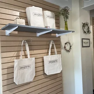 two totes hanging on a wall