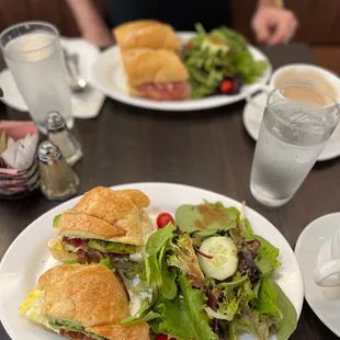 a plate of sandwiches and a salad
