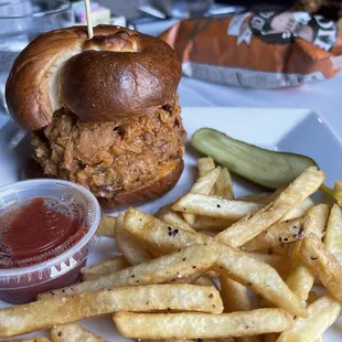 Perfectly seasoned fries with tasty pulled pork on a brioche bun.