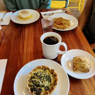 a man sitting at a table with breakfast items