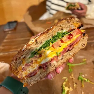Breakfast Sandwich, which had eggs, arugula, tomatoes, avocado, turkey bacon, American cheese, and chipotle mayo on a multigrain bread.