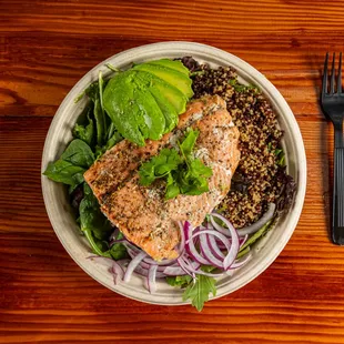 a bowl of food on a wooden table