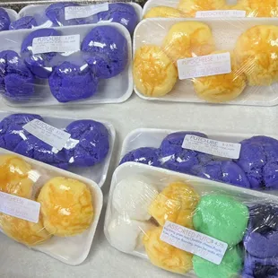 a variety of doughnuts in plastic containers