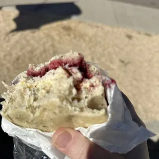 a hand holding a pastry