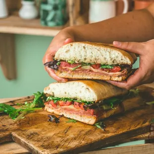 a person holding a sandwich