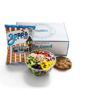 a box of bread and a bowl of salad