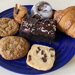 front:shortbread cookie, chocchip cookie, brown sug cookie, monkey bread (1/2 eaten), cinnamon roll, plain croissant, wacky cake (I smudged)