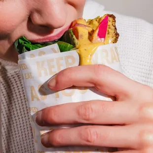a woman eating a sandwich
