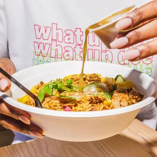 a person holding a bowl of food