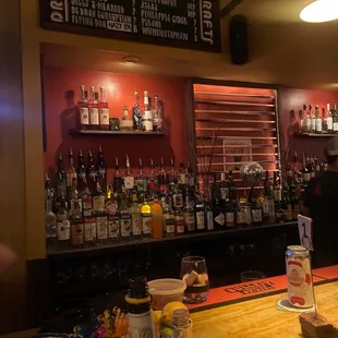 a bar with a lot of bottles of alcohol