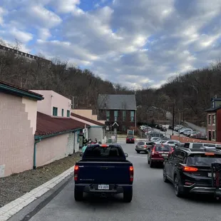 a street with cars parked on both sides of the road
