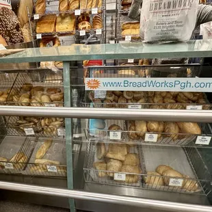 Display case of salt sticks, baguettes, wheat rolls, etc.