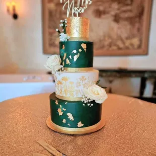 a green and gold wedding cake