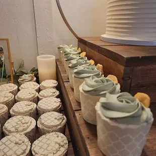 a table of cupcakes and a cake