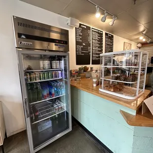 a refridgerator and a counter with drinks