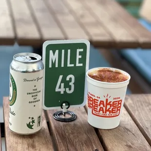 a cup of coffee and a mile sign