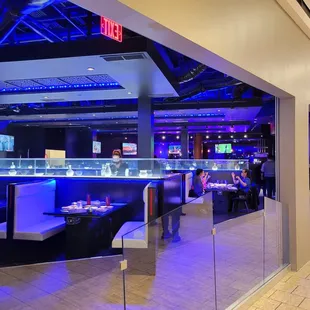 the inside of a restaurant with blue lighting