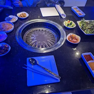 a hot pot with various foods on a table