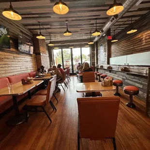 a restaurant with wood floors and tables