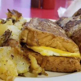 French toast, egg &amp; bacon breakfast sandwich with potatoes