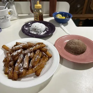 a plate of french fries and a donut