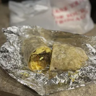 a burrito wrapped in aluminum foil