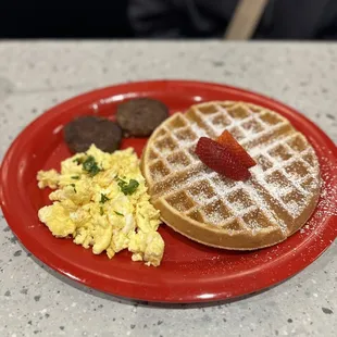 a waffle, scrambled eggs and sausage