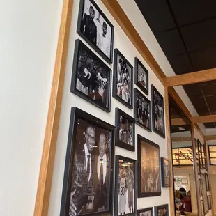 a wall full of framed photos