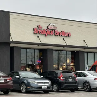 cars parked in front of a restaurant