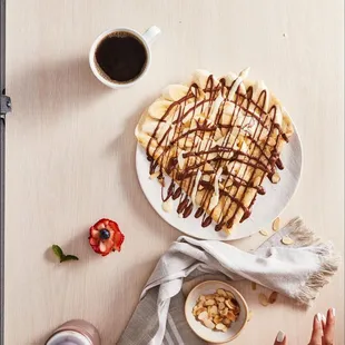 a plate of waffles and a cup of coffee