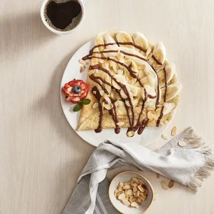 a crepe with chocolate drizzle and fruit