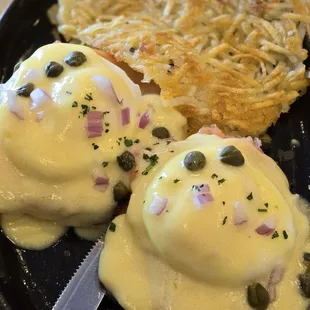 Smoked salmon eggs benedict with delicious hollandaise, diced red onion, and capers.  Perfection!