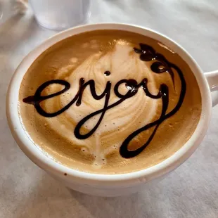 a cappuccino with the word enjoy