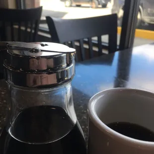 a cup of coffee and a salt shaker