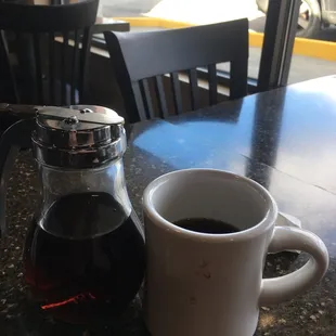a coffee pot and a cup of coffee