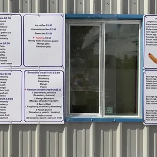 menus and prices on the side of a building