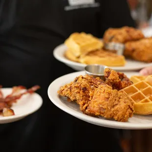 two plates of fried chicken and waffles