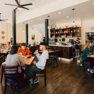 people sitting at tables in a restaurant