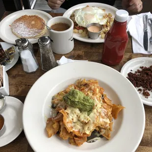 Chilaquiles (chorizo, sour cream, red sauce on the side), supreme chorizo hash with side of pancake.