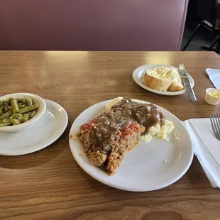 Meatloaf, mashed potatoes with gravy, green beans and s thick slice of rustic bread. A deal for $6.99!
